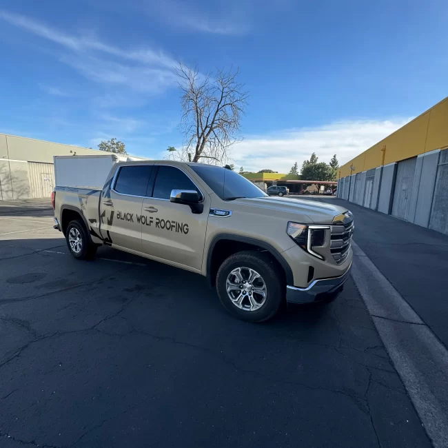 Black Wolf Roofing GMC truck wrap front view