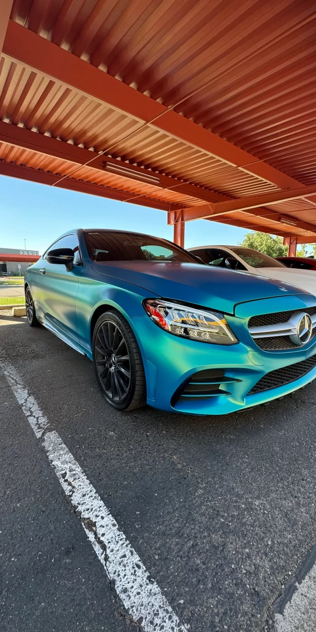 Teal color-shift wrap on Mercedes coupe
