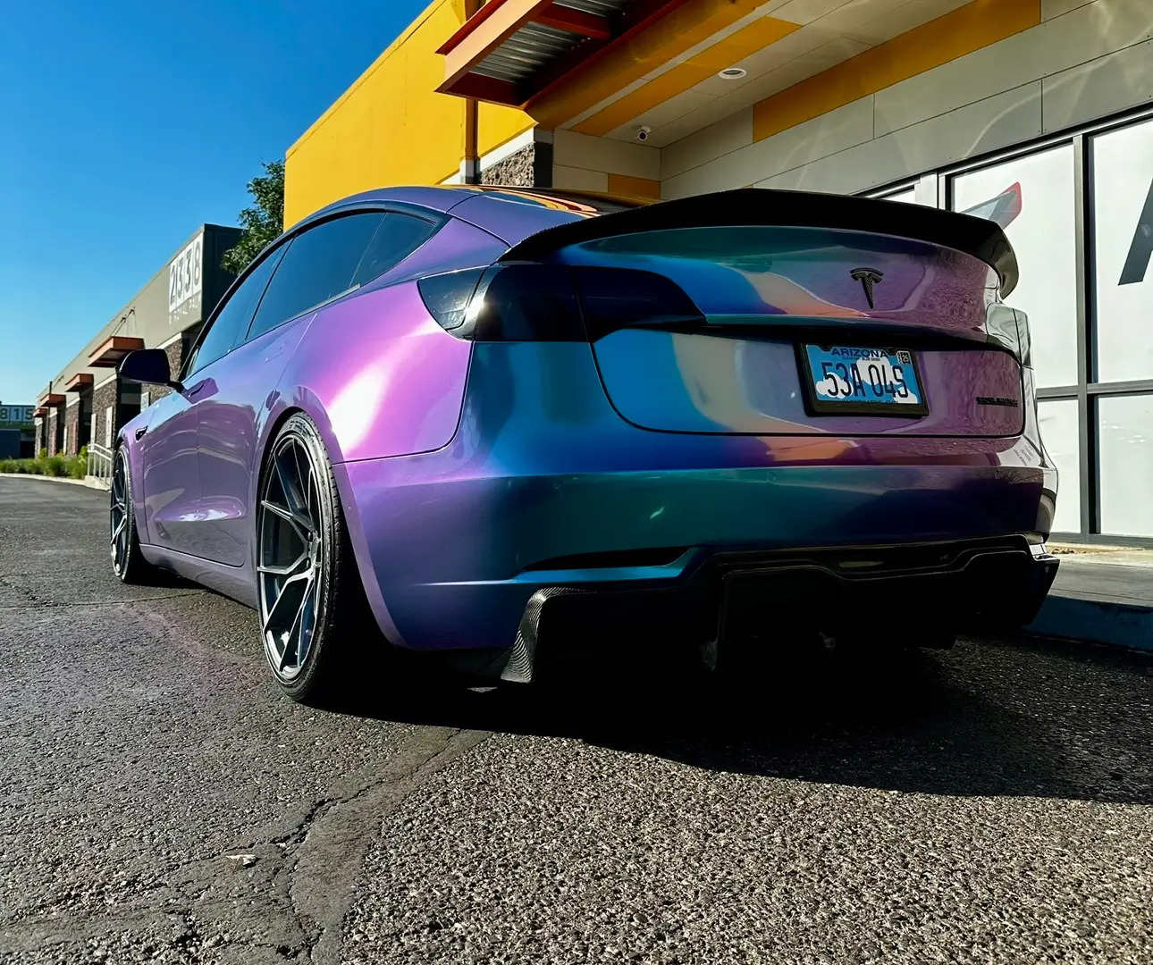 Purple-to-teal color-shift wrap on Tesla Model 3